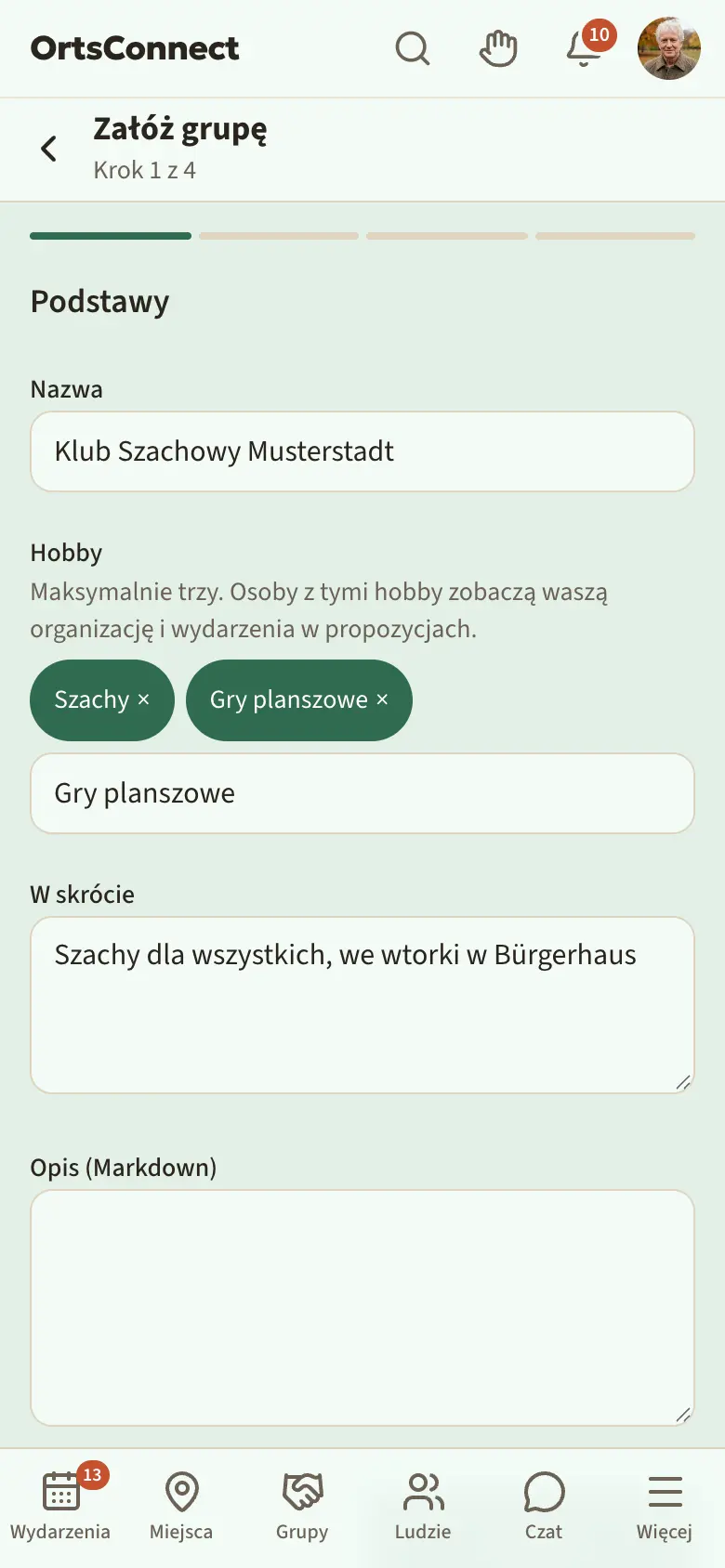 Kreator „Załóż grupę”, krok 1 „Podstawy” z wpisaną nazwą i dwoma wybranymi hobby w „Hobby”, pod spodem pole „Szukaj hobby …”